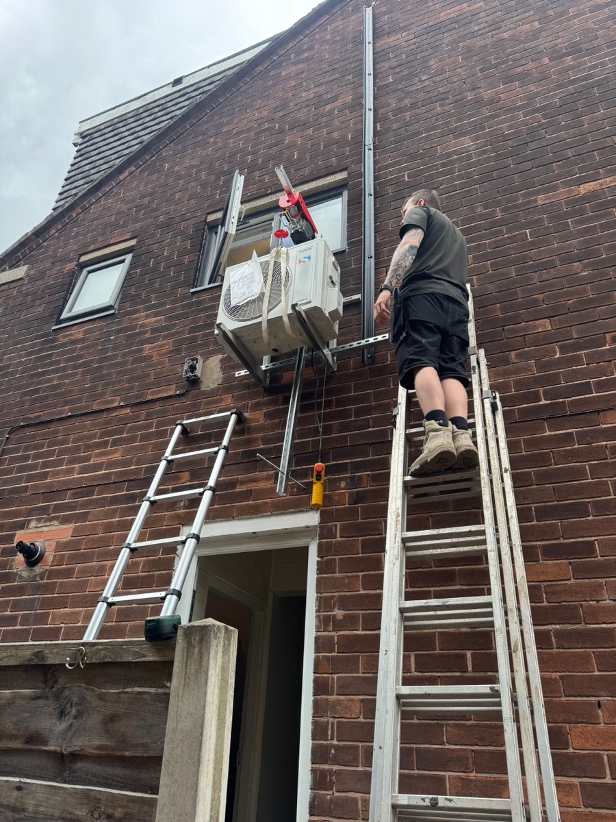 Sinclair 2.5kW air conditioning outdoor unit being hoisted into place in Swinton